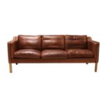 A Danish brown leather three-seater settee,