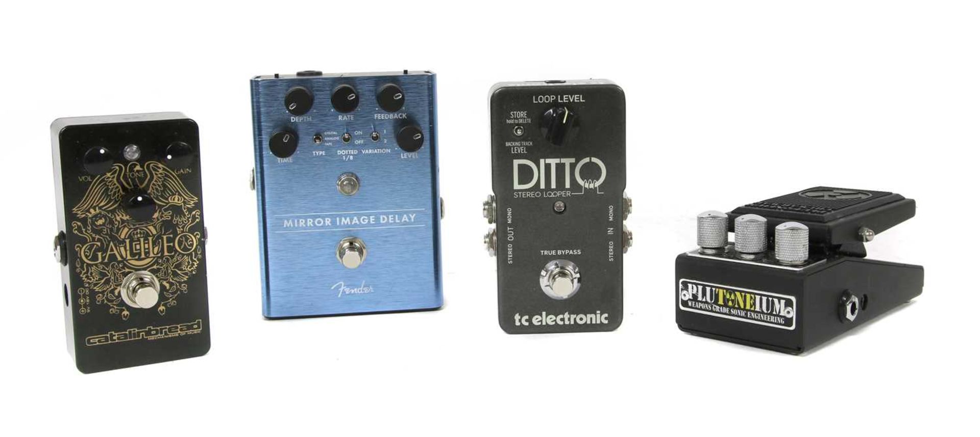 A group of four guitar effects pedals,