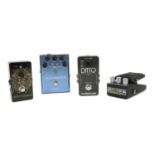 A group of four guitar effects pedals,