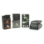 A group of four guitar effects pedals,