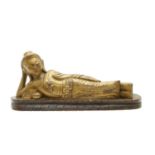 A caved wood figure of a reclining buddha