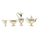 A four piece silver plated embossed tea set,