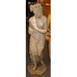 A composite stone figure of a semi-clad female in classical dress,