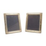 A large pair of silver photograph frames,