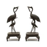 A pair of Japanese bronze candle holders,