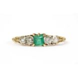 A gold emerald and diamond ring,