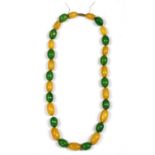 A single row slightly graduated oval yellow and green Bakelite bead necklace,