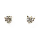 A pair of white gold single stone diamond stud earrings,