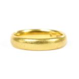 A 22ct gold court section wedding ring,