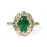 A gold emerald and diamond cluster ring,