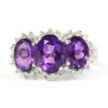 A 9ct white gold amethyst and diamond triple cluster ring,