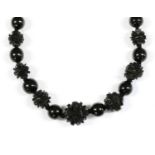 A single row graduated carved jet bead necklace,