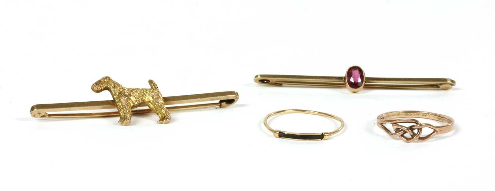 A gold dog bar brooch,