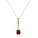 An 18ct white gold ruby and diamond pendant,
