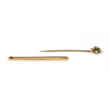 A plain gold bar brooch,