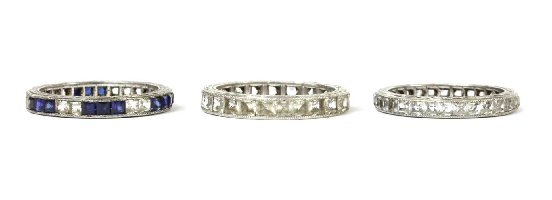 Three silver paste set full eternity rings,