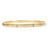 A plain gold D section bangle,