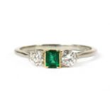 A platinum and gold, emerald and diamond three stone ring,