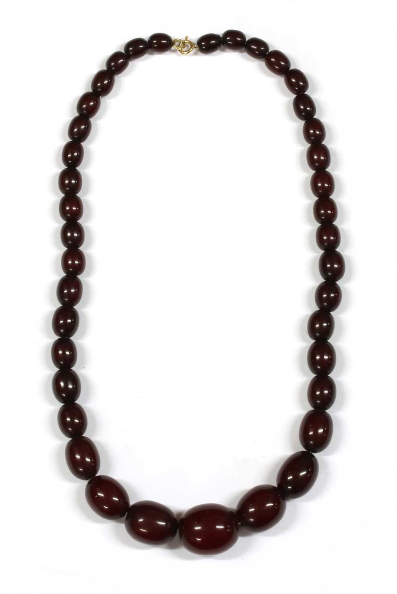 A single row graduated oval oxblood coloured Bakelite bead necklace,