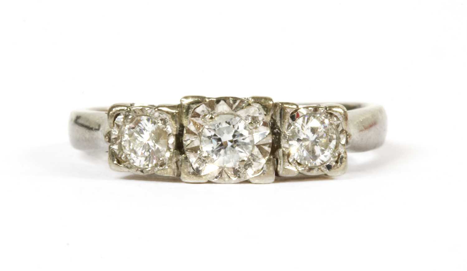 A 9ct white gold three stone diamond ring,