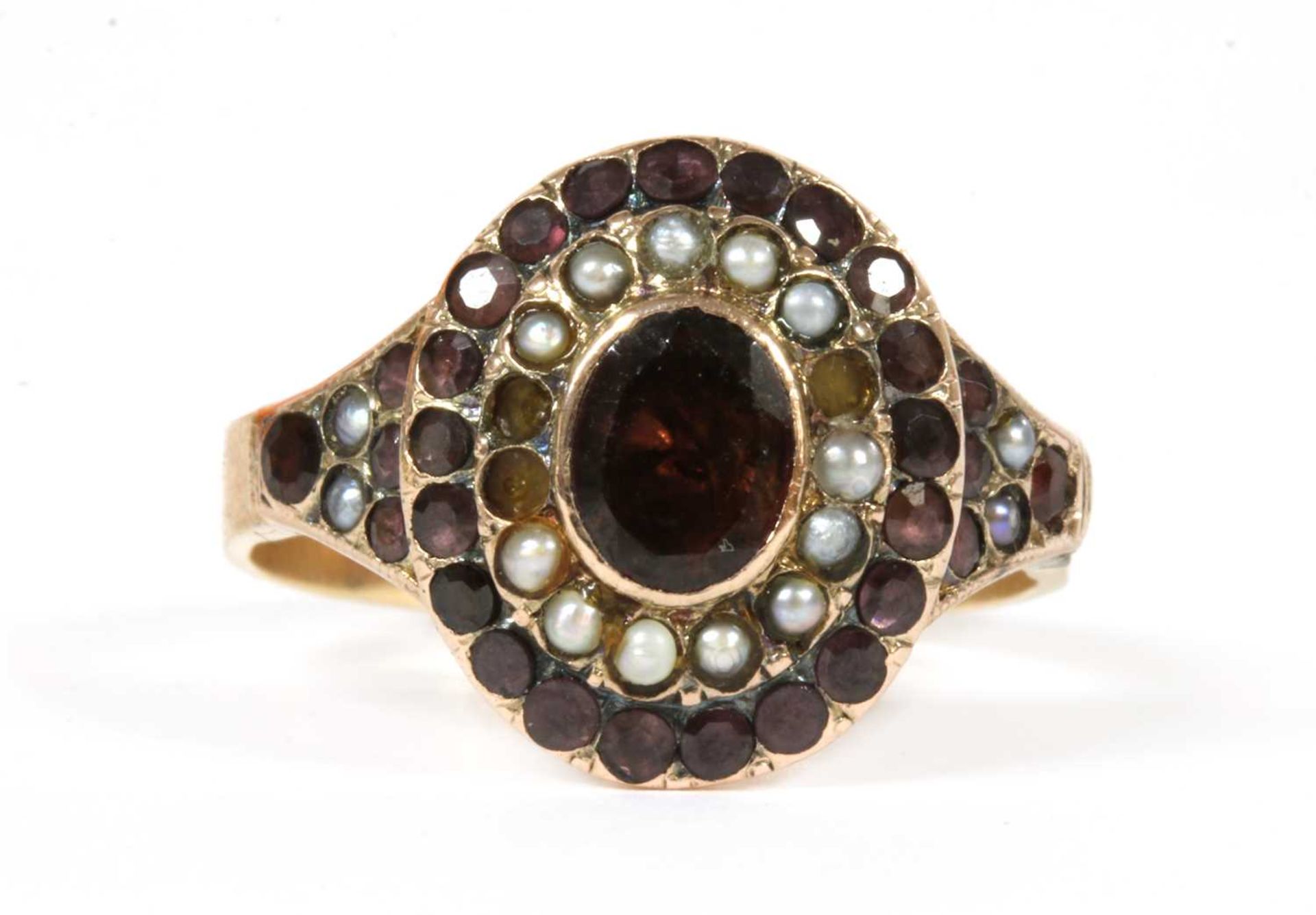 A Victorian gold garnet and split pearl cluster,