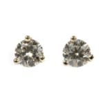 A pair of white gold single stone diamond stud earrings,