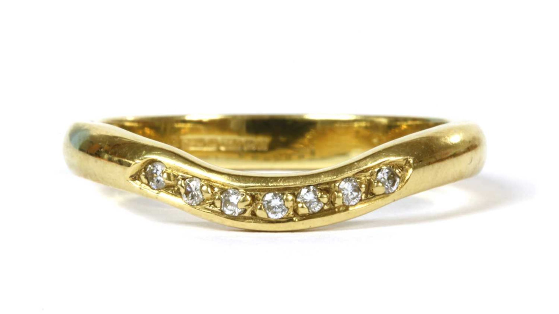 An 18ct gold diamond set shaped wedding ring,