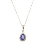 A white gold tanzanite and diamond pendant,