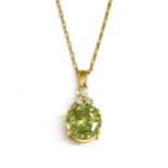 A gold sphene and cubic zirconia pendant,