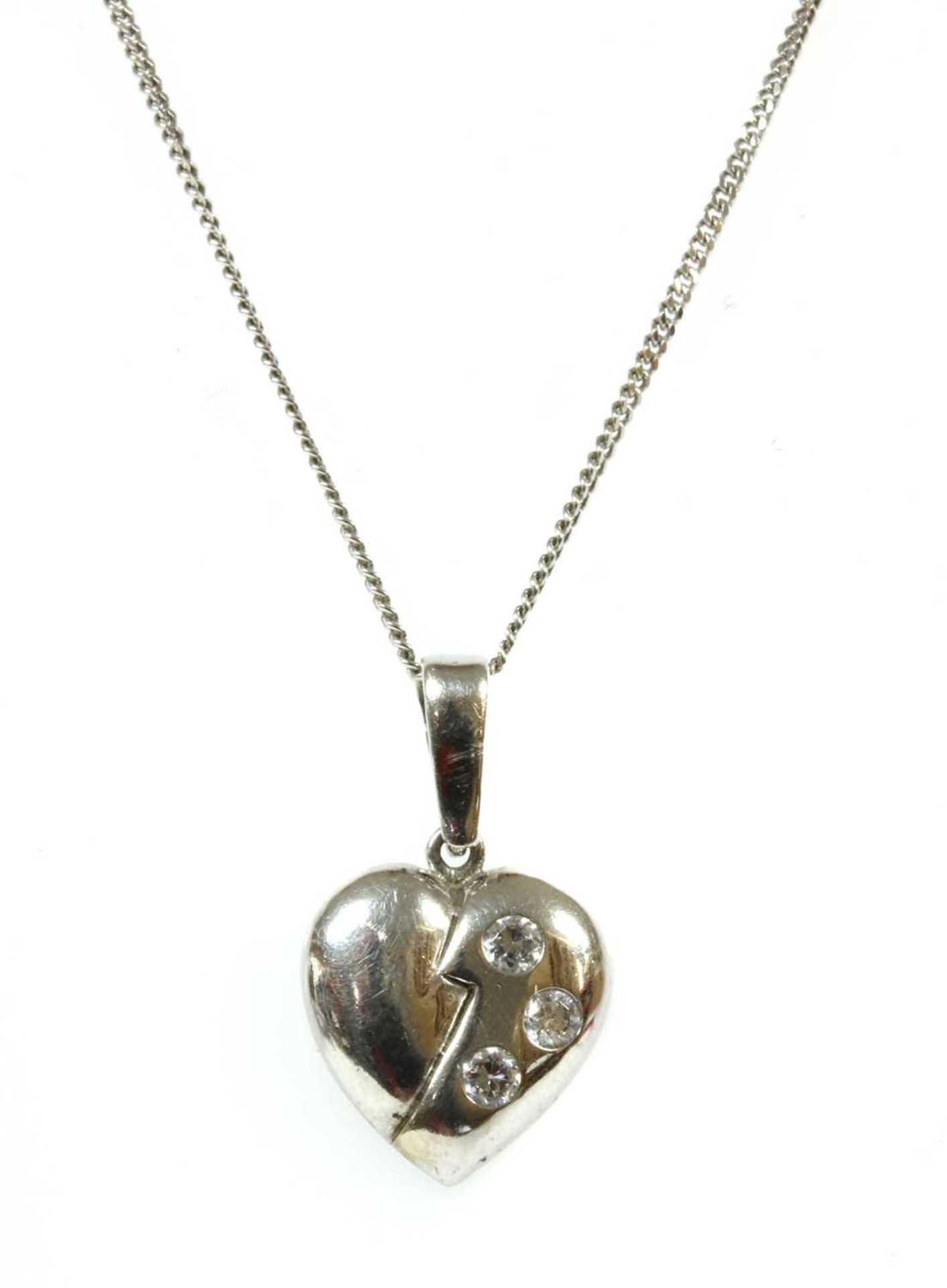 A 9ct white gold diamond set heart pendant,