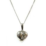 A 9ct white gold diamond set heart pendant,