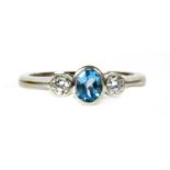 A 9ct white gold blue topaz and diamond three stone ring,