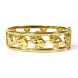 An Italian hinged oval openwork cat motif bangle,