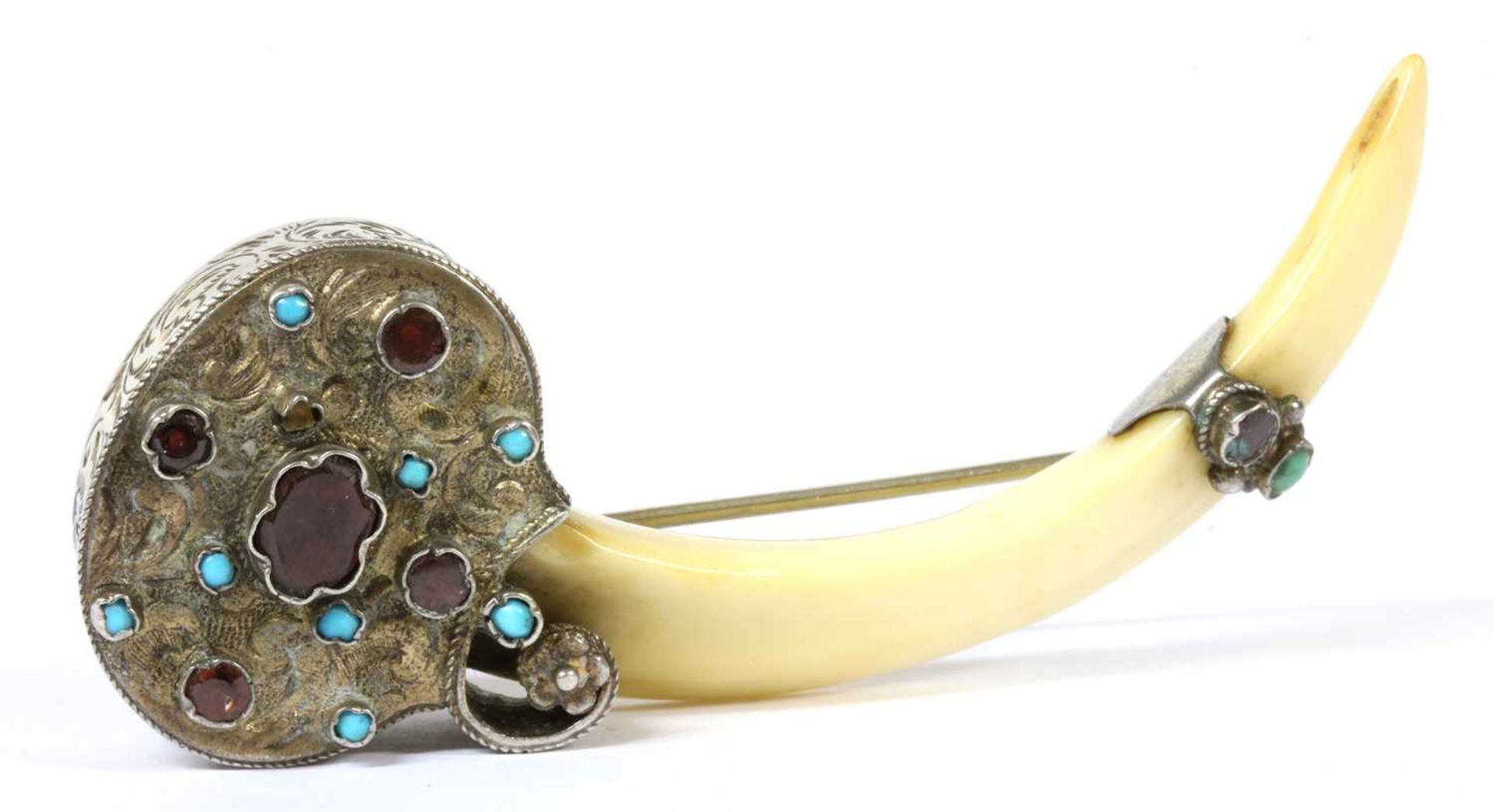 A silver mounted tusk brooch,