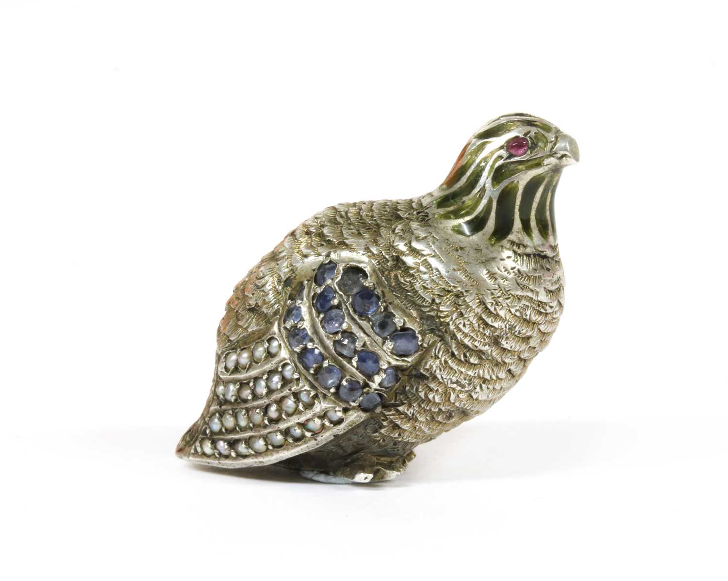 A silver sculpture of a partridge,