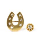 A gold diamond horseshoe brooch,