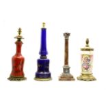 Four 19th century coloured glass and other oil lamps