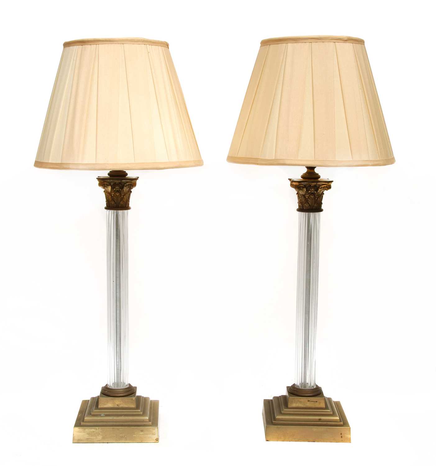 A pair of brass and glass Corinthian column table lamps,