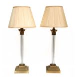 A pair of brass and glass Corinthian column table lamps,
