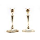 A pair of George V silver candlesticks,