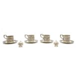 A set of four Indian silver cup holders and saucers,
