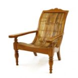 A modern teak and rattan planter's chair