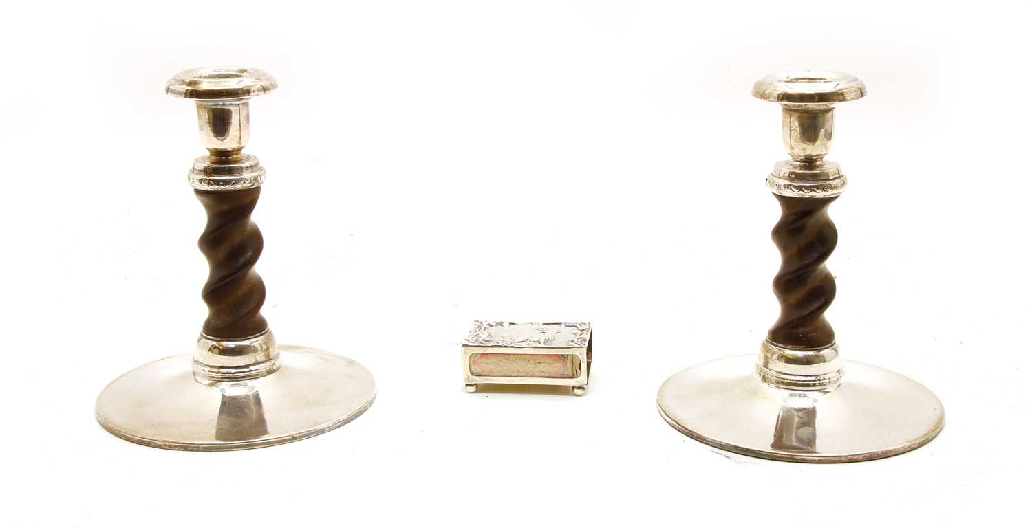 A pair of turned wooden on white metal mounted candlesticks,