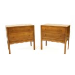 A pair of bedside chests,