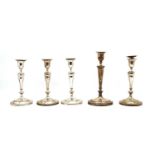 A set of four silver plated candlesticks,