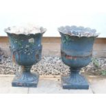 A pair of cast iron garden urns,