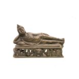 An ornamental bronze of a reclining Buddha