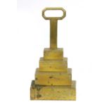 A brass door stop,