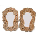 A pair of eastern carved wooden mirrors,