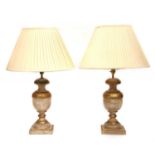 A pair of turned and parcel gilt table lamps,